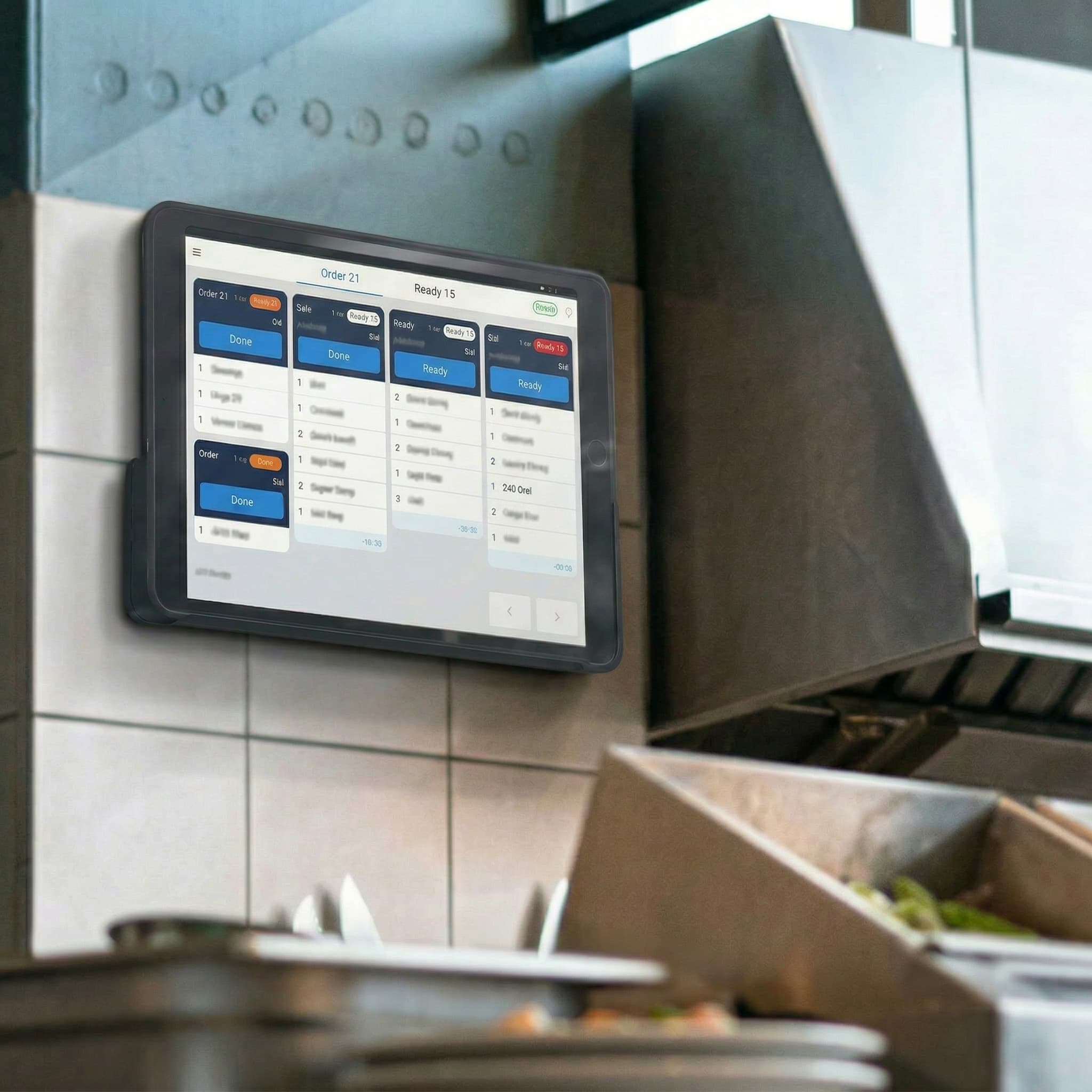 Foodteria Kitchen Display Screen (KDS) mounted on a restaurant wall